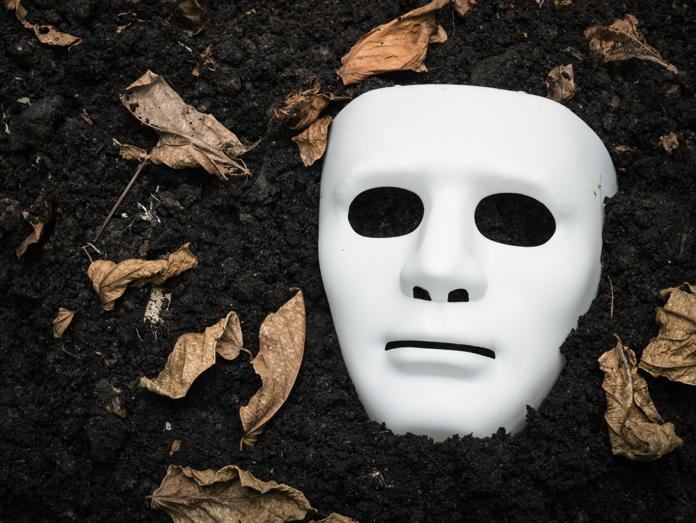 White Scary Halloween mask on the ground